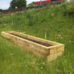 long wooden raised planter at goldthorpe embankment